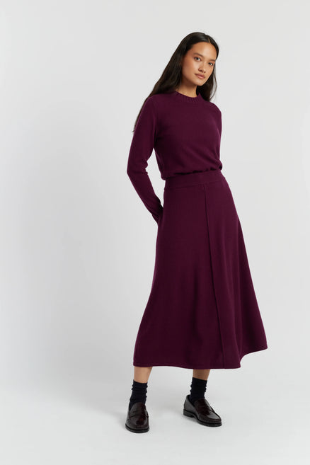 Woman wearing a purple outfit on a white background