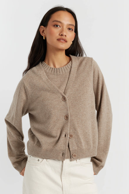 Woman wearing a beige cardigan on a white background
