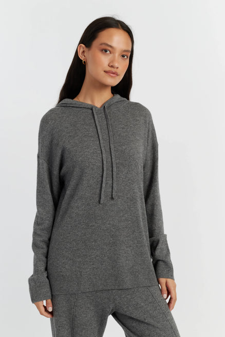 Woman wearing a gray hoodie on a white background