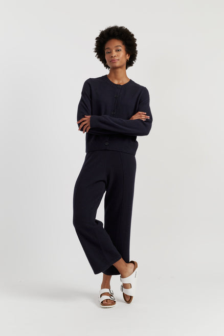 Person wearing a black outfit on a white background