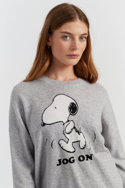 Woman wearing a grey sweatshirt with a Snoopy graphic and 'Jog On' text on a white background